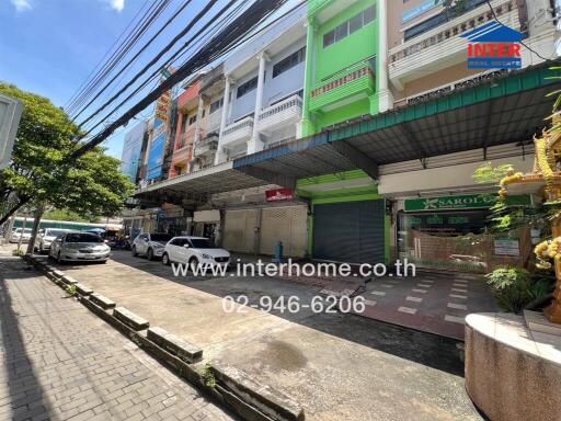 Street view of commercial buildings with shop fronts