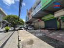 Street view of commercial buildings with contact information