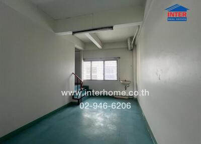 Empty room with staircase and a sink