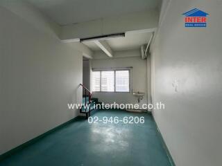 Empty room with staircase and a sink