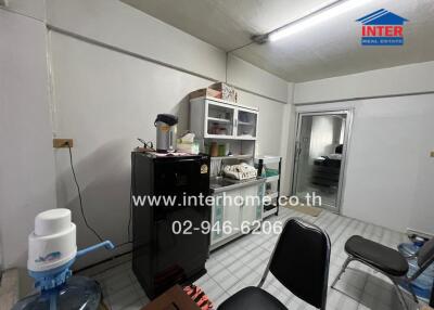 Kitchen area with appliances and furniture