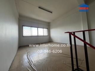 Empty room with window and staircase