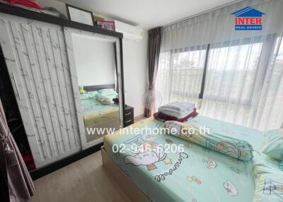 Bedroom with large window and playful bedding