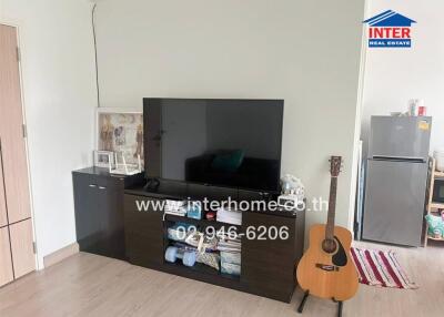 Living room with TV, cabinet, and guitar