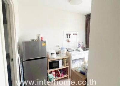 Compact kitchen area with appliances and storage