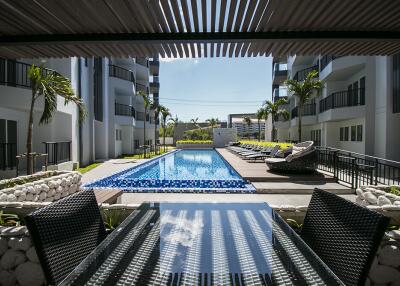 Outdoor view of swimming pool and seating area between buildings