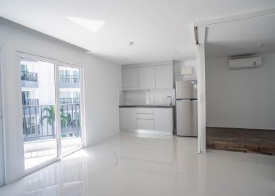 Modern kitchen with stainless steel appliances and balcony view