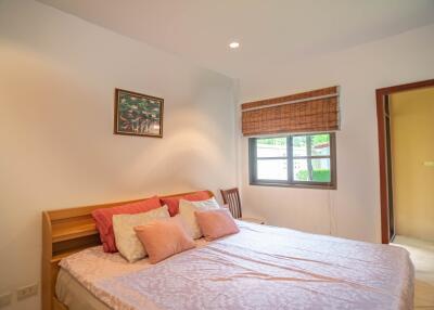 Cozy bedroom with a large bed and window view