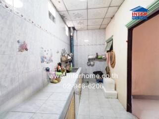 Kitchen with tiled walls and countertops