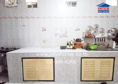 kitchen with wall-mounted cabinets and cooking utensils