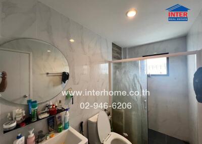 Modern bathroom with shower and various amenities