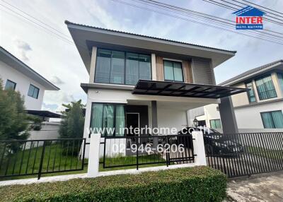 Modern two-story house with gated fence and front yard