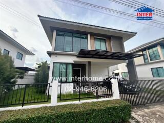 Modern two-story house with gated fence and front yard