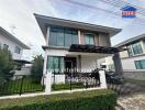 Modern two-story house with gated fence and front yard