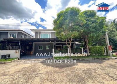 Exterior view of a residential building with driveway and greenery