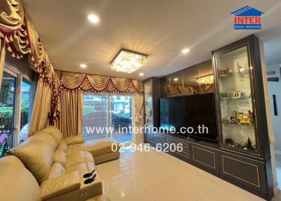 Living room with large TV and luxurious decor