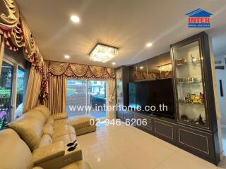 Living room with large TV and luxurious decor