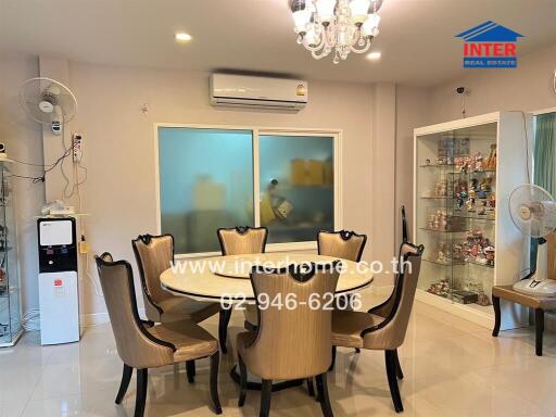 well-lit dining area with a table set for six, air conditioning, and display cabinets