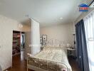 Cozy bedroom with a bed, curtain divider, and bookshelves