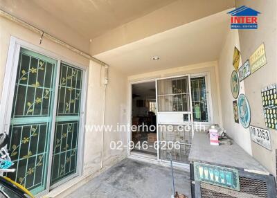 Front entrance of a house with glass doors and windows