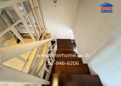 Wooden staircase with white railing