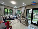 Living room with large windows, sofa, and children's toys