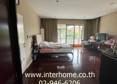 Spacious bedroom with large bed and balcony access