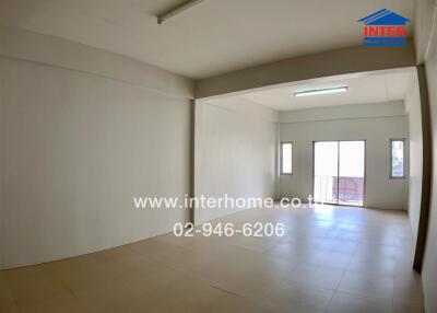 Spacious unfurnished living room with large windows and natural light