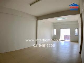 Spacious unfurnished living room with large windows and natural light