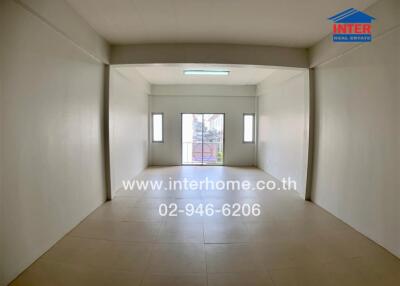 Spacious empty room with large windows