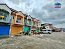 Front view of a row of townhouses with various storefronts on the ground floor.