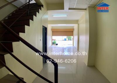 Property entryway with staircase and reflective flooring