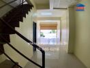 Property entryway with staircase and reflective flooring