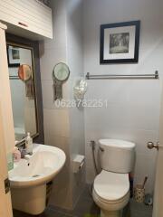 Bathroom with sink, toilet, and mirror