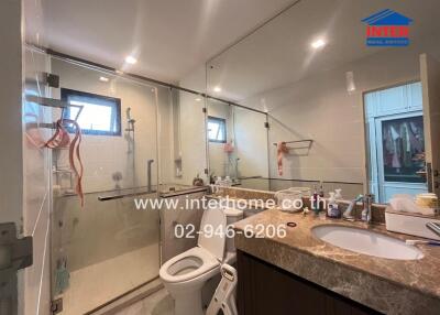 Modern bathroom with shower area, toilet, and sink counter