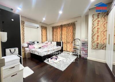 Well-lit bedroom with air conditioning and a double bed