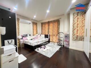 Well-lit bedroom with air conditioning and a double bed