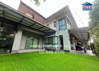 Exterior view of a modern house with a green lawn