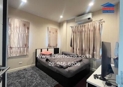 Bedroom with bed, curtains, and air conditioning