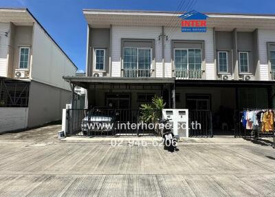 Front view of a townhouse with a gated entrance