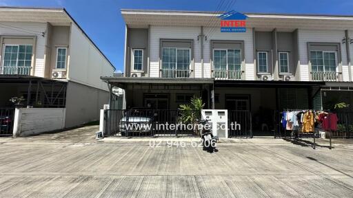 Front view of a townhouse with a gated entrance