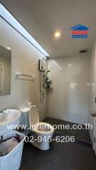 Modern bathroom with a shower, toilet, and sink