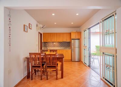 Bright kitchen and dining area with wooden cabinets and sliding doors