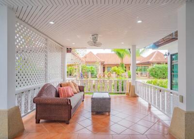 Outdoor covered living area with rattan furniture