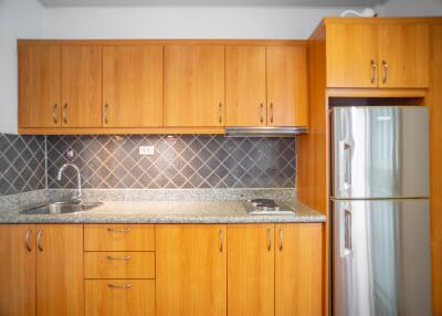 Modern kitchen with wooden cabinets and stainless steel appliances