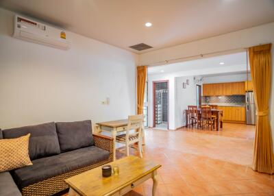 Spacious living room adjacent to dining area and kitchen