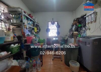 Kitchen with storage shelves, appliances, and utensils