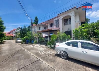 Exterior view of a residential building with cars parked in front