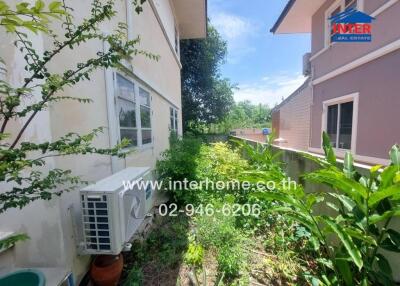 Side view of the property showing garden area with air conditioner unit