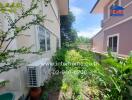 Side view of the property showing garden area with air conditioner unit